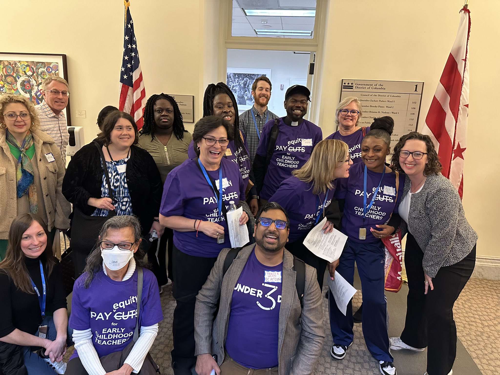 Photo of advocates wearing purple Under3DC t-shirts gathered with Councilmember Brianne K Nadeau outside of her Wilson Building office